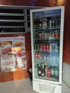 an open refrigerator full of soda and drinks at Hotel Palace Vila Sônia in São Paulo