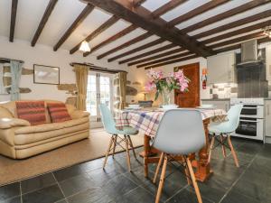 a living room with a table and chairs and a couch at Trevenning Barn in Bodmin