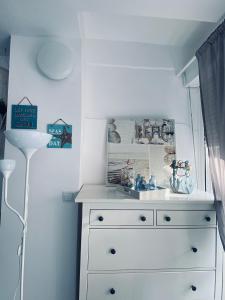 a white dresser in a room with a window at Arenales Beach Boutique Apartment in Arenales del Sol