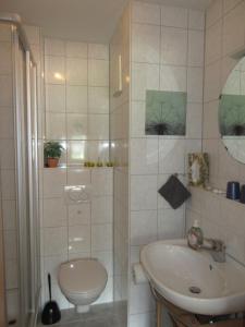 a bathroom with a sink and a toilet at Wehrlemartinshof in Simonswald