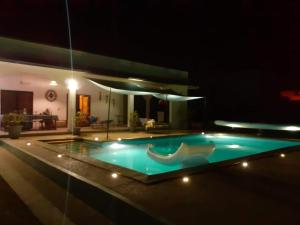 a swimming pool in a house at night at La Somonoise in Somone
