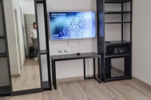 a tv on a wall in a living room with a mirror at HVB 34 Lifestyle 4 Superior in Bibione