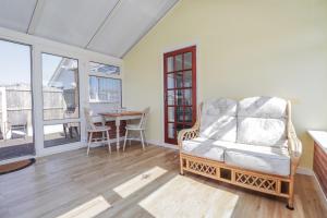 a living room with a chair and a table at Echo Beach in Seasalter