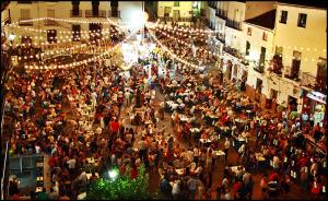 a large crowd of people in a street with lights at Casa Pepe La Rosa Atico in Tolox