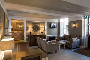 
a living room filled with furniture and a large window at Best Western Wessex Royale Hotel Dorchester in Dorchester
