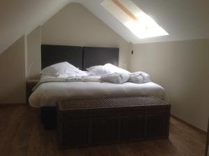 En eller flere senge i et værelse på Trilogie Appartementen & Gasterij