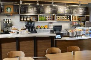 a fast food restaurant with a counter and tables at Sonesta Select Dallas Central Expressway in Dallas