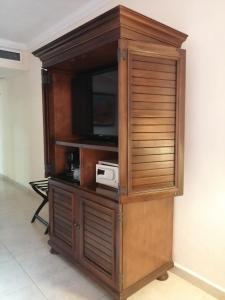 a wooden entertainment center with a television in it at Holiday Inn Merida, an IHG Hotel in Mérida