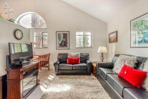 a living room with a couch and a tv at Powder Village G-1 | Discover Sunriver in Sunriver