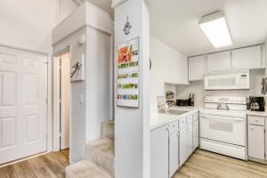 a kitchen with white cabinets and white appliances at Powder Village G-1 | Discover Sunriver in Sunriver