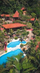 an aerial view of a resort with two swimming pools at Hotel El Jardin in Montezuma
