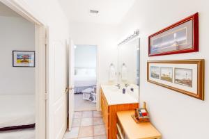 a bathroom with a sink and a mirror at Acapulco Unit A in South Padre Island +23 photos