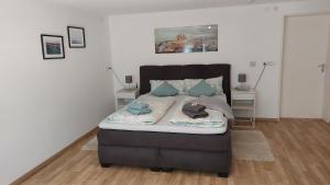 a bedroom with a bed with blue pillows on it at Ferienwohnung Esther in Singen