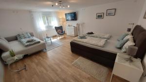a living room with a bed and a couch at Ferienwohnung Esther in Singen