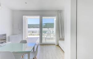 a white living room with a view of the ocean at Bilo 4 Confort in Stintino
