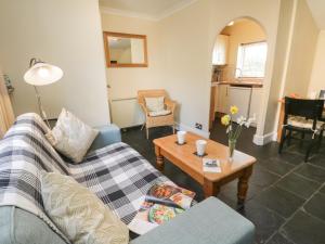 a living room with a couch and a table at Cosy Cottage in Potto