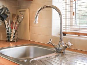 a kitchen sink with a chrome kitchen faucet at Cosy Cottage in Potto +16 photos
