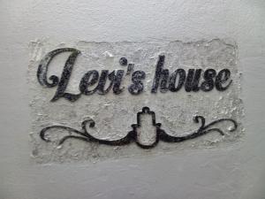 a sign that says love and house on a wall at Levis house Eilat in Eilat