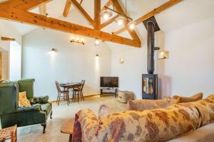 a living room with a couch and a fireplace at Basil's Barn in Whitby