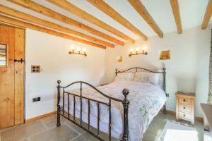 a bedroom with a bed and a wooden ceiling at Basil's Barn in Whitby