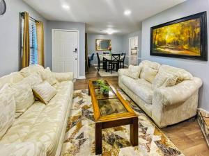 a living room with two white couches and a table at NEW! Luxe Cottage with Big Backyard 10 Mi to Augusta in Evans