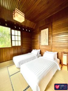 A bed or beds in a room at The Onsen Hot Spring Resort