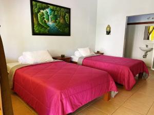 Postel nebo postele na pokoji v ubytování Bali Cottage Sambirenteng
