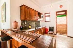 a kitchen with wooden cabinets and a wooden table at Aurora Lagoon Front in Negombo