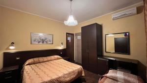Postel nebo postele na pokoji v ubytování Hotel Il Cavaliere Nero