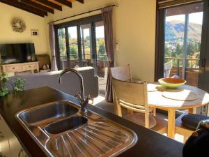 uma cozinha com um lavatório e uma mesa com uma sala de jantar em TekapoB2 Lakeview Apartment em Lake Tekapo