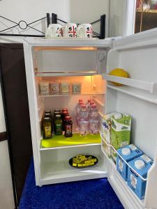 
a refrigerator filled with lots of food and drinks at L'Oasi di Chia in Chia
