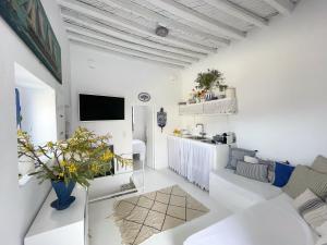 a living room with white walls and a white couch at Serifos White in Serifos Chora