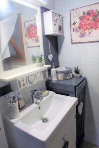 a bathroom with a sink and a mirror at Purple House - Arboriamar Platamona in Sorso