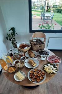 a table with a bunch of food on it at Logis Auberge des Aulnettes in Houlgate