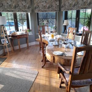 uma sala de jantar com uma mesa de madeira e cadeiras em Shadowvale E34X773 em Tipperary