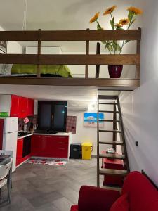 a living room with a loft bed and a kitchen at Appartamentino sul lago di Bolsena in Gradoli