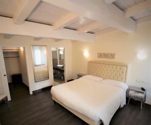 Postel nebo postele na pokoji v ubytování Hotel Patavium