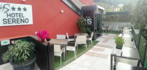 a restaurant with tables and chairs and a red wall at Hotel Sereno in Sestri Levante