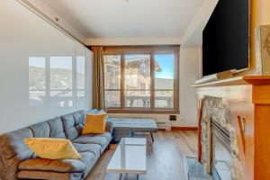 a living room with a couch and a fireplace at Snow Star Sanctuary in Olympic Valley