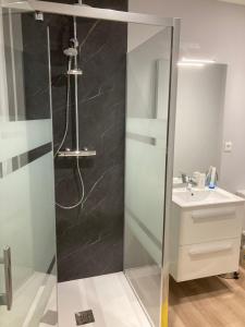 ein Bad mit einer Dusche und einem Waschbecken in der Unterkunft Le petit monas in Civaux