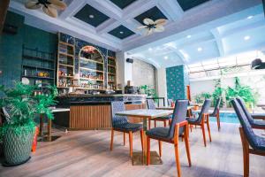 a restaurant with a table and chairs and a bar at Mettavary Hotel in Phnom Penh