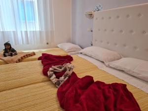 Giường trong phòng chung tại Hotel Marconi Miramare