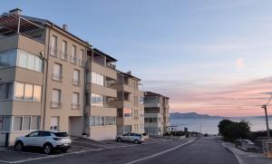 a building with two cars parked in a parking lot at Two stars - Villa Sunce in Senj