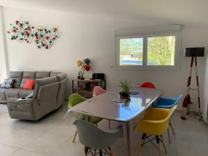 a living room with a table and chairs at LES GITES D'AULT. Meublé Le Hâble d'Ault. in Ault