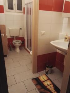 a bathroom with a toilet and a sink at Cinecasa di Andrea e Cristina in Turin