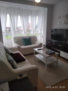 Televízia a/alebo spoločenská miestnosť v ubytovaní apartamento melide