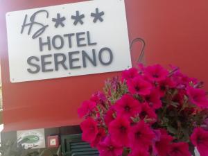 a sign for a hotel serrano with pink flowers at Hotel Sereno in Sestri Levante