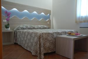 En eller flere senge i et værelse på Hotel Villa Robinia
