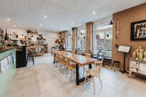 a kitchen and dining room with a table and chairs at Emma's B&B LUNGERN - Self Check-in Hotel in Lungern