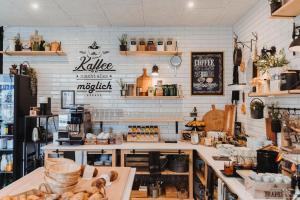 a bakery with white brick walls and a counter at Emma's B&B LUNGERN - Self Check-in Hotel in Lungern